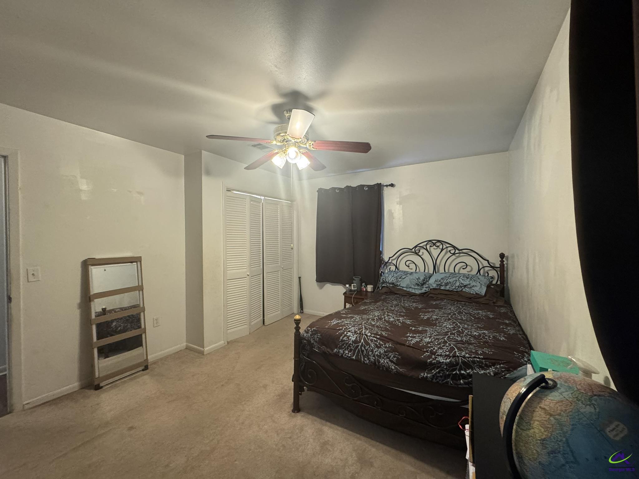 1032 Elberta Road Warner Robins, GA 31093 - Photo 17 of 26 a bedroom with a bed and a chandelier