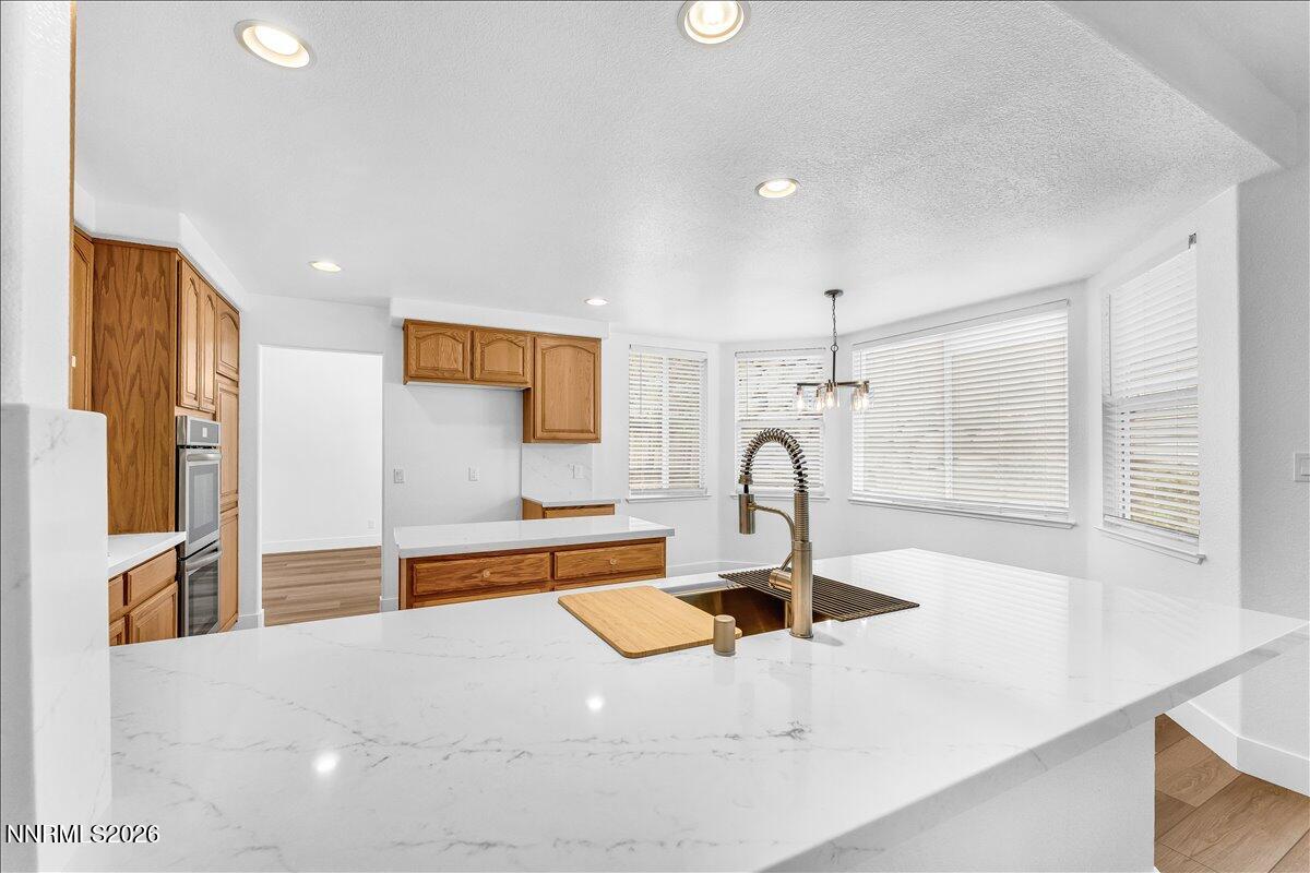 2329 Red Maple Court Reno, NV 89523 - Photo 14 of 39 a kitchen with stainless steel appliances kitchen island a sink a stove and a window