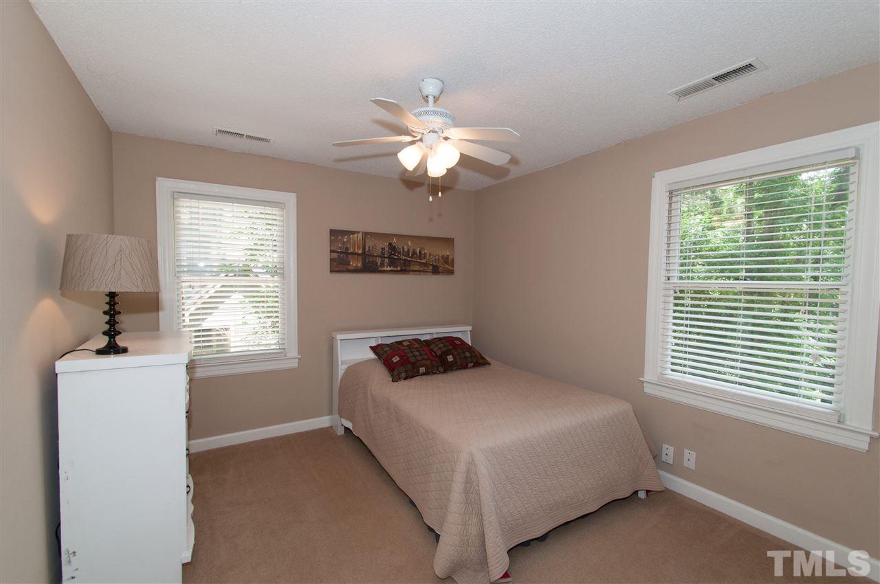 7304 Chicora Court Raleigh, NC 27615 - Photo 14 of 25 a bedroom with a bed and a window