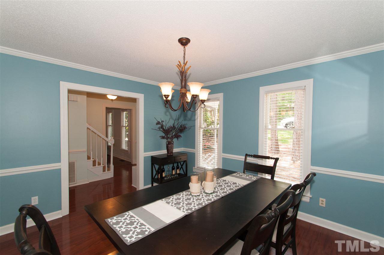 7304 Chicora Court Raleigh, NC 27615 - Photo 6 of 25 a view of a dining room with furniture window and wooden floor