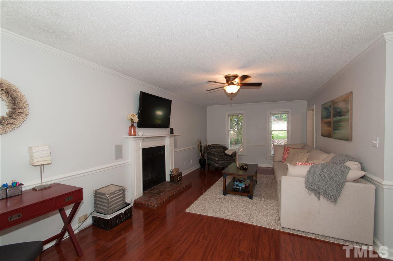 7304 Chicora Court Raleigh, NC 27615 - Photo 7 of 25 a living room with furniture and a flat screen tv