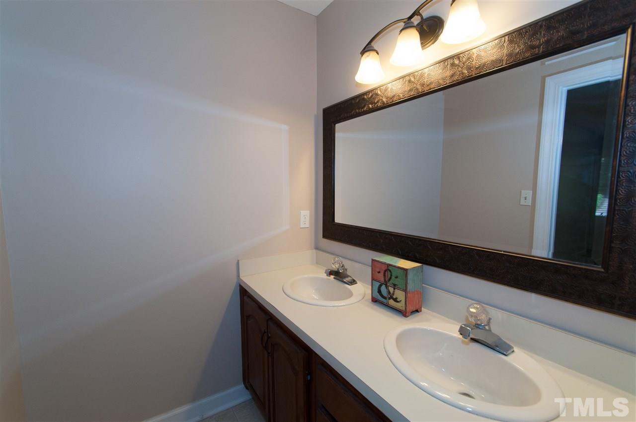7304 Chicora Court Raleigh, NC 27615 - Photo 10 of 25 a bathroom with a sink and a mirror