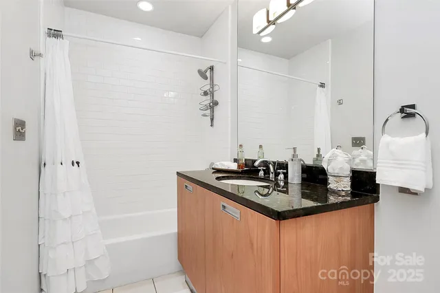 a bathroom with a double vanity sink a mirror and shower
