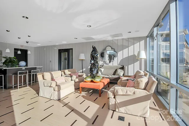 a living room with fireplace furniture and a large window