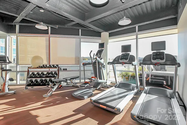 a room with gym equipment and windows