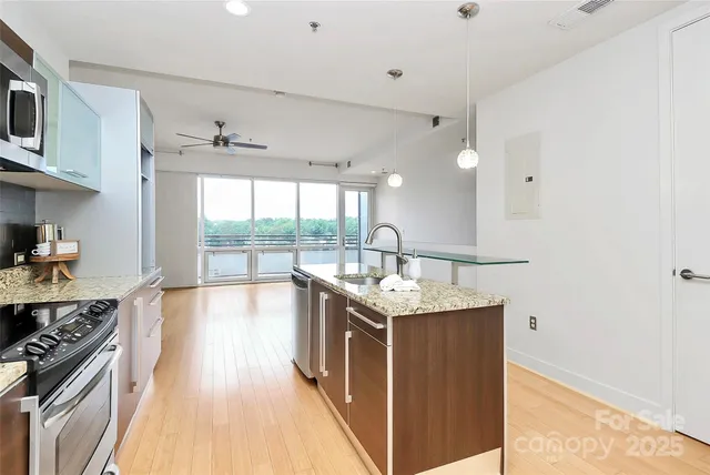 a kitchen with stainless steel appliances granite countertop a stove and a sink