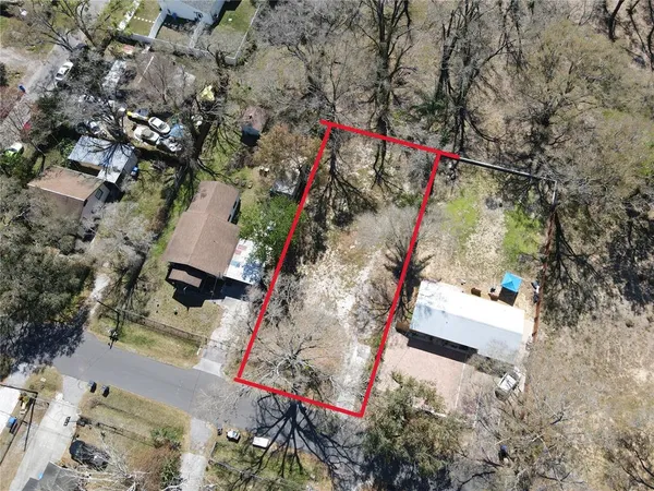 an aerial view of a houses with a yard
