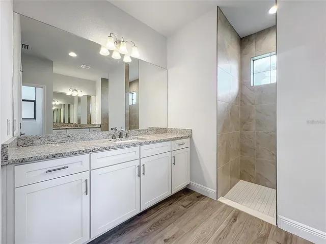 a bathroom with a double vanity sink and a mirror