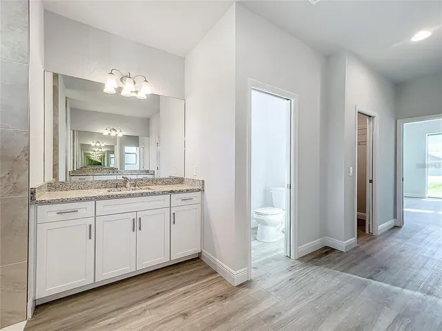a bathroom with a double vanity sink and a mirror
