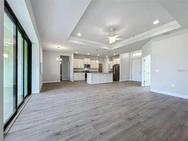 a view of a kitchen with a refrigerator and a large window