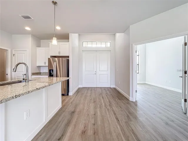 a kitchen with granite countertop wooden floors and sink