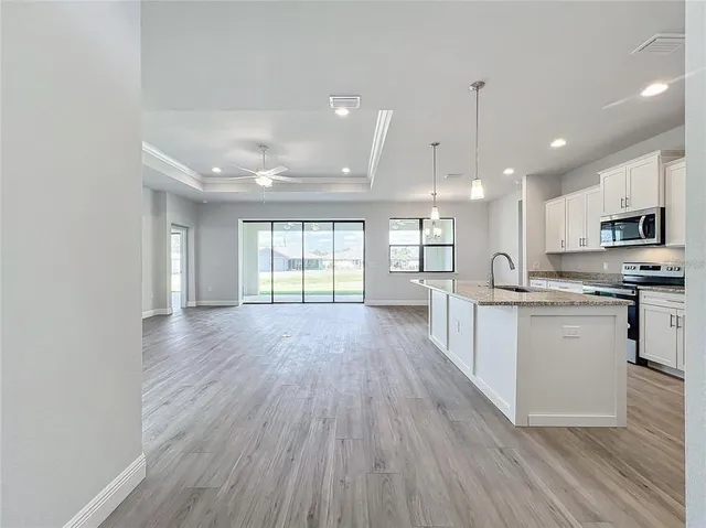 a view of kitchen with sink and wooden floor