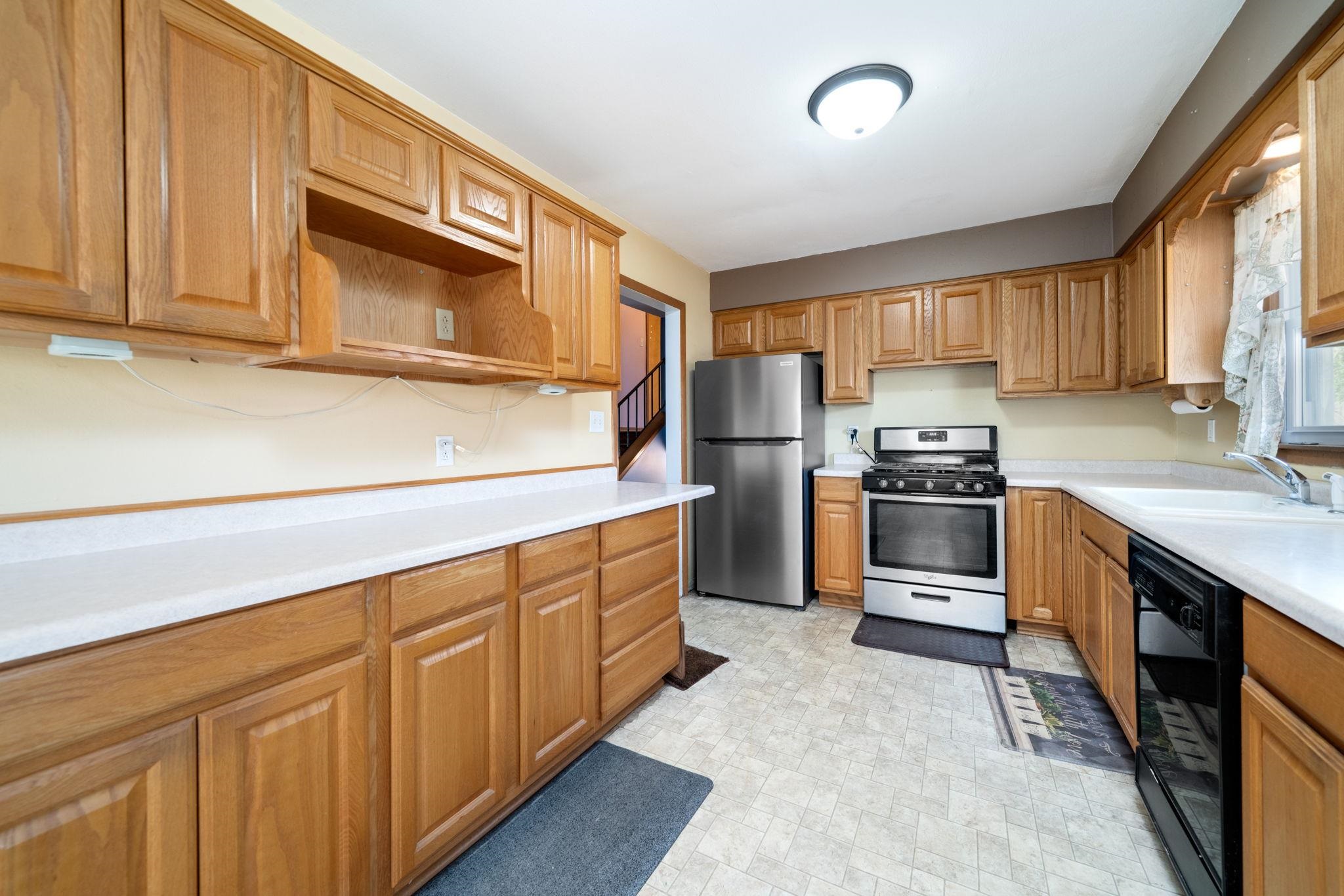 1611 Notre Dame Road Rockford, IL 61103 - Photo 8 of 33 a kitchen with granite countertop a sink stainless steel appliances and cabinets