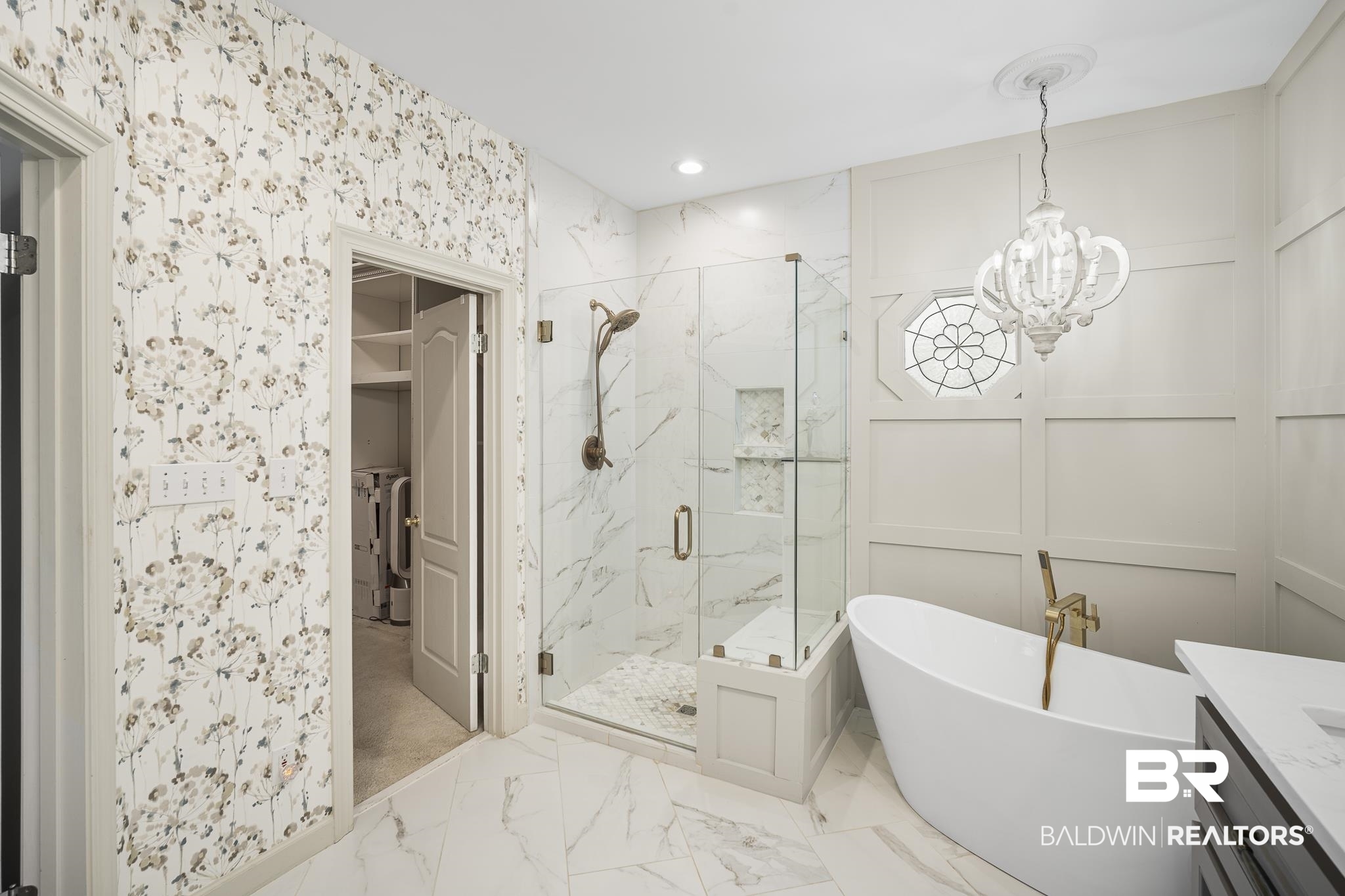 19876 Hunters Loop Fairhope, AL 36532 - Photo 22 of 40 Bathroom featuring marble finish floors, a marble finish shower, a decorative wall, a freestanding tub, and a chandelier