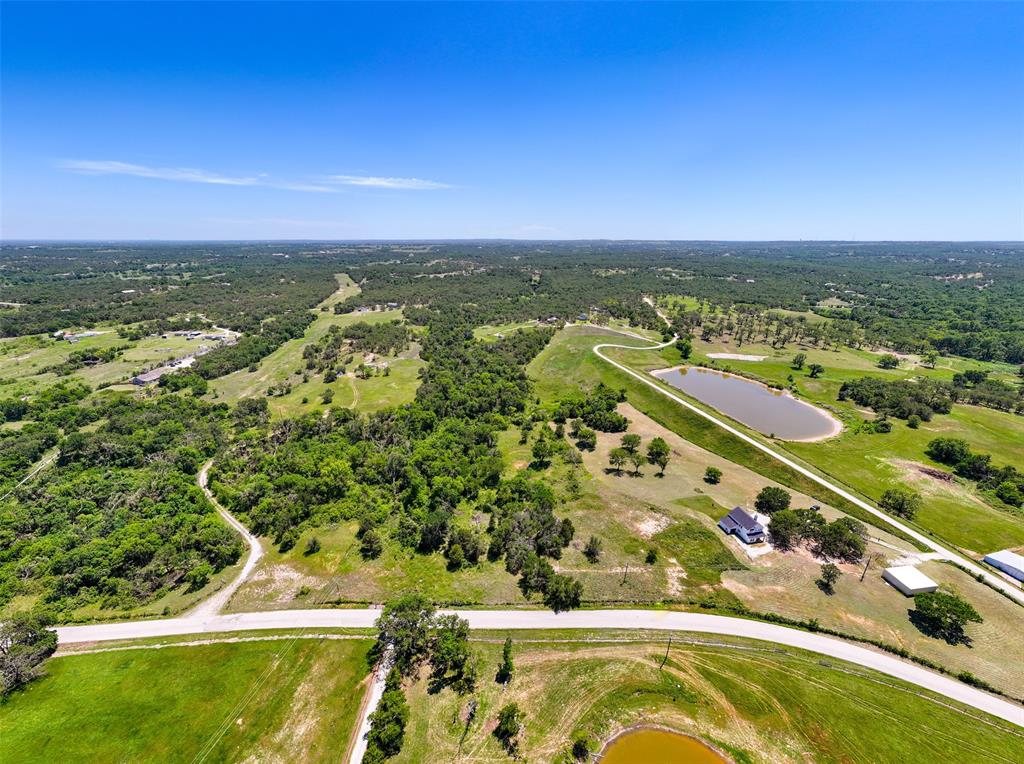1874 County Road Springtown, TX 76082 - Photo 3 of 24 an aerial view of residential houses with outdoor space and trees