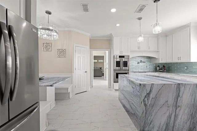 a kitchen with stainless steel appliances granite countertop a sink stove and cabinets