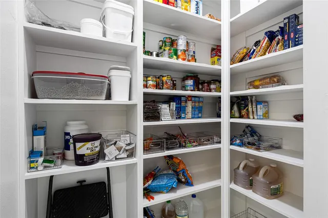 a bathroom with a granite countertop sink and a window