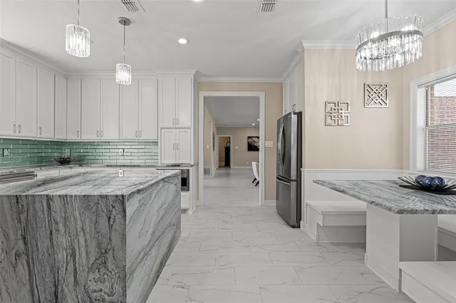 a kitchen with stainless steel appliances granite countertop a refrigerator and a sink
