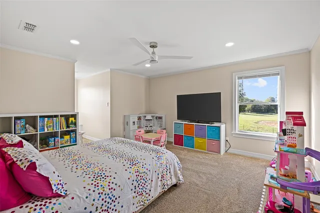 a living room with furniture and a bookshelf