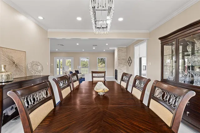 a large kitchen with granite countertop a stove a sink a refrigerator and white cabinets granite countertops with wooden floor