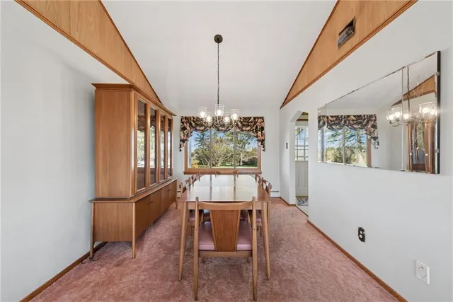 a view of a dining room with furniture and window