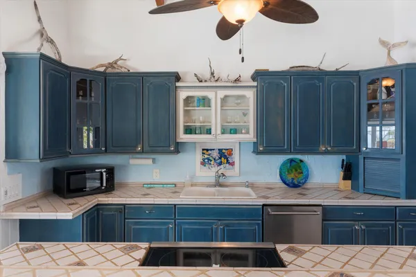 a bathroom with a granite countertop sink and washing machine
