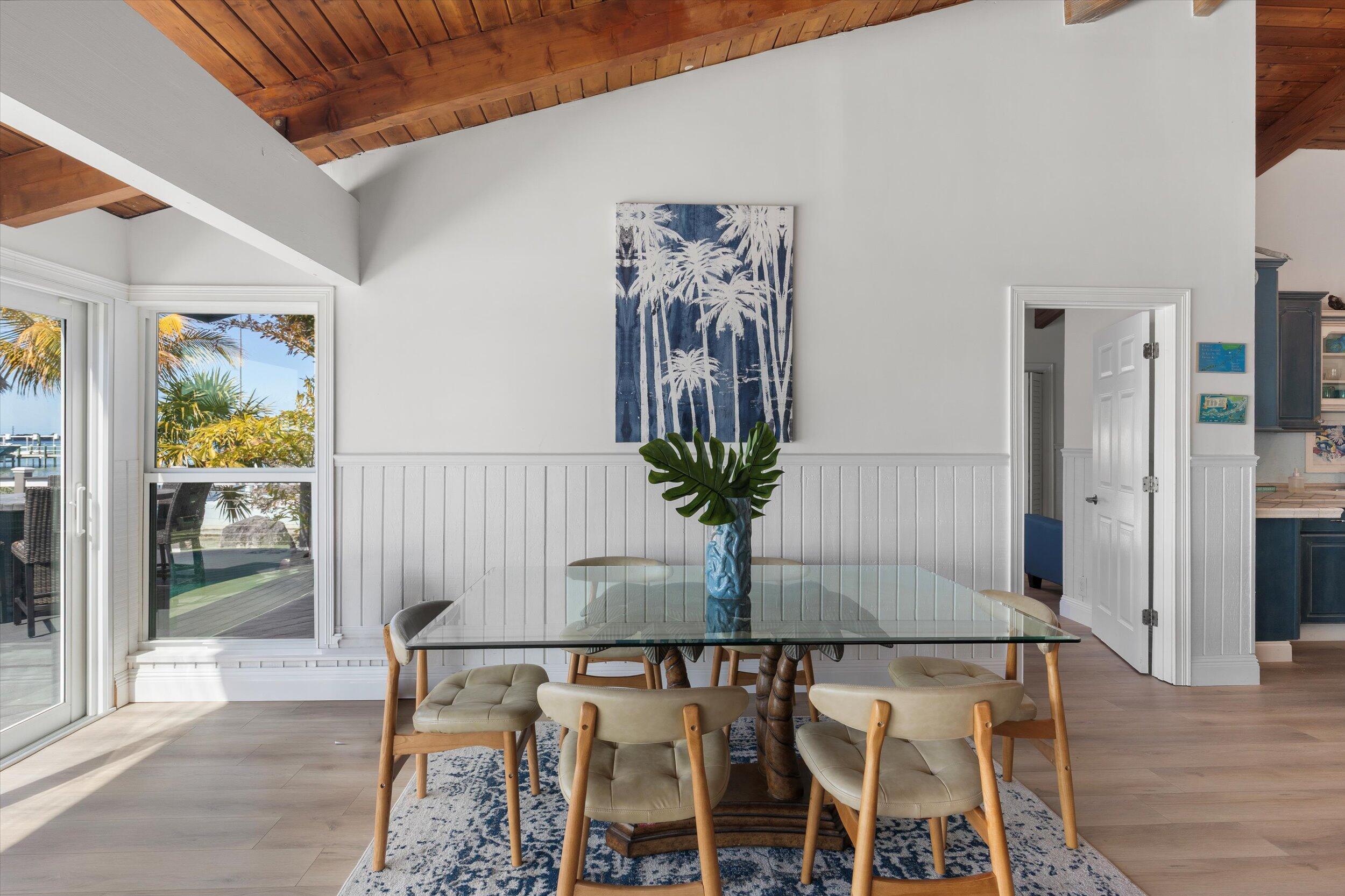 29581 Richard Road Big Pine Key, FL 33043 - Photo 28 of 78 a view of a dining room with furniture and wooden floor