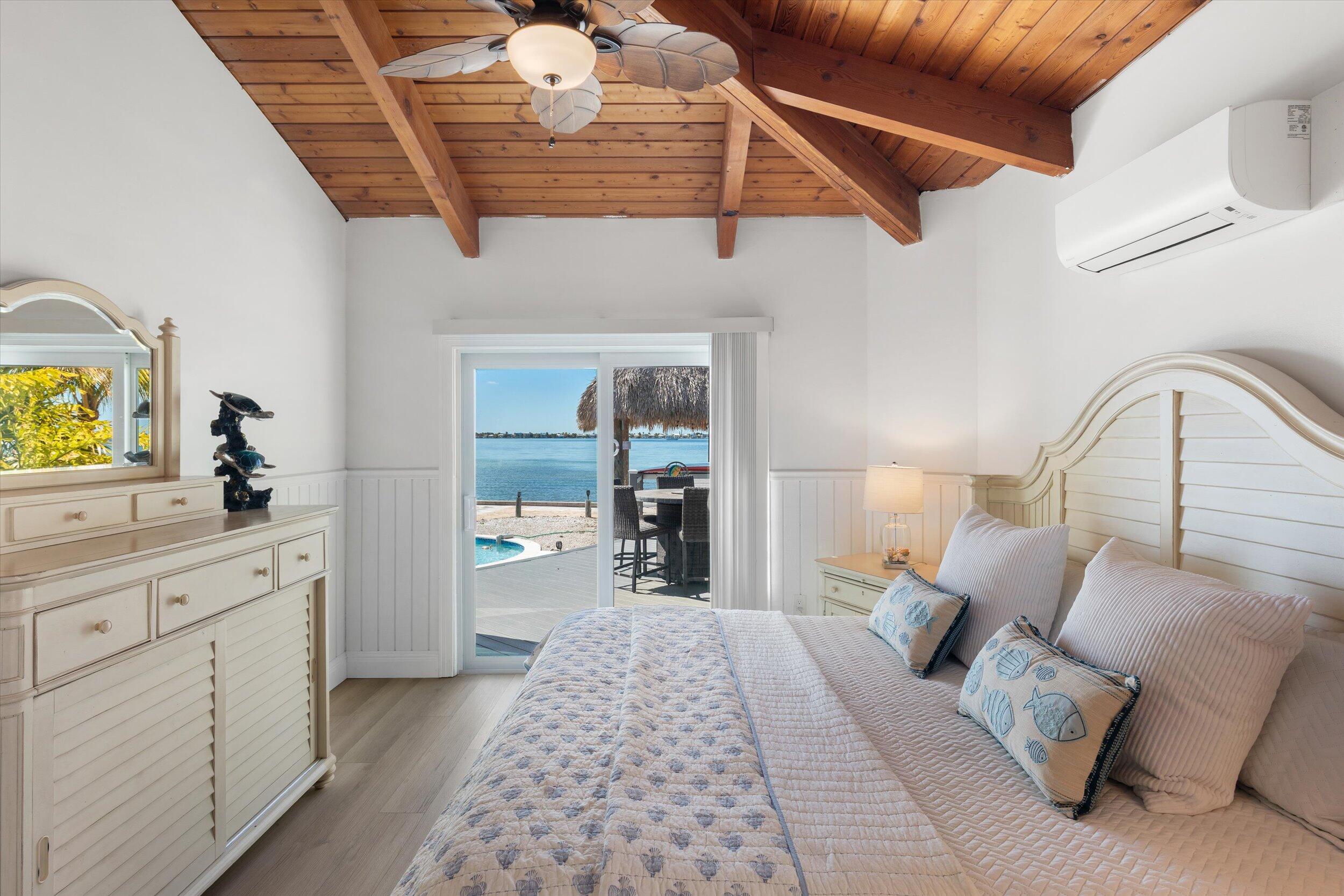 29581 Richard Road Big Pine Key, FL 33043 - Photo 30 of 78 a bed room with a bed and a large window