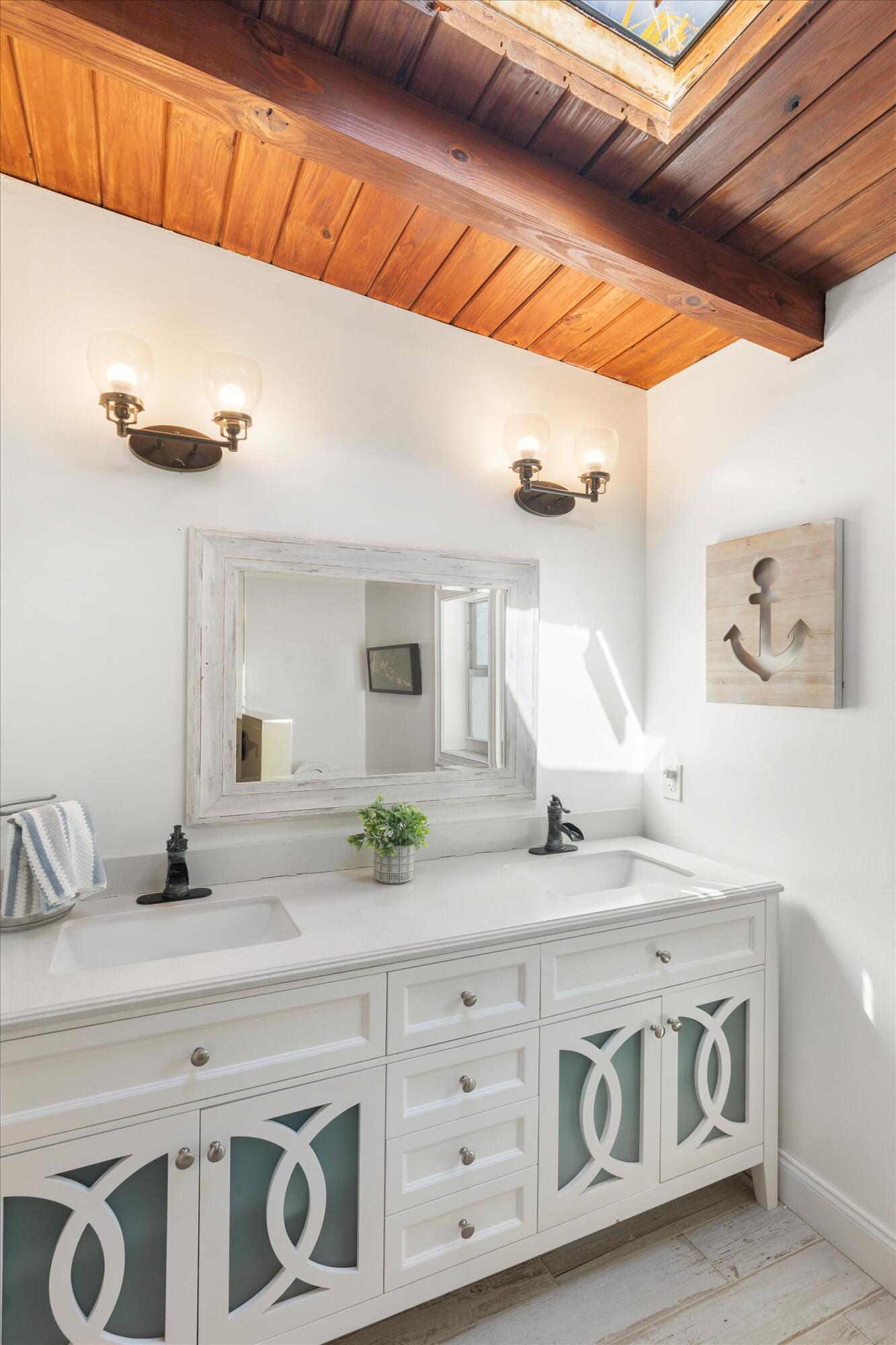 29581 Richard Road Big Pine Key, FL 33043 - Photo 40 of 78 a bathroom with a granite countertop sink and a mirror