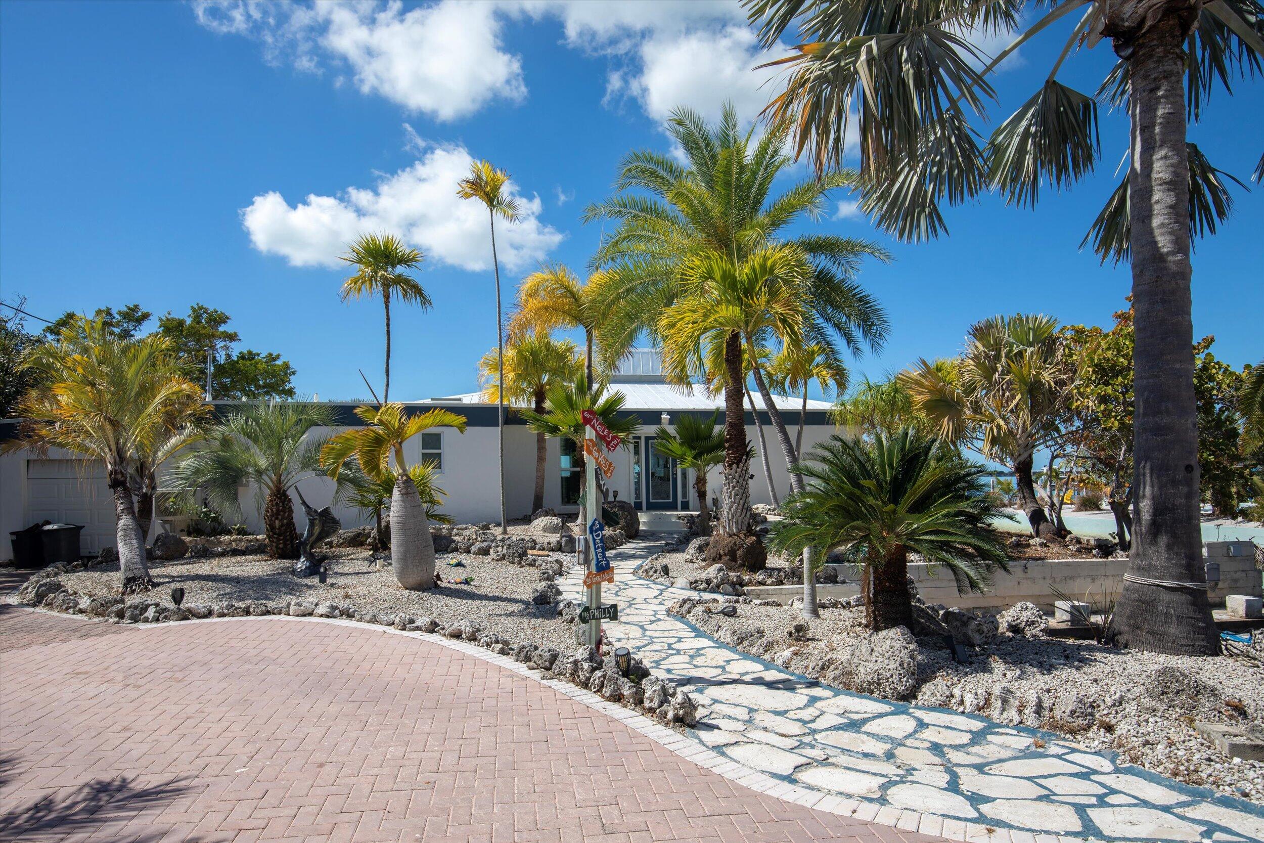 29581 Richard Road Big Pine Key, FL 33043 - Photo 6 of 78 a view of a backyard with a water fountain and potted plants