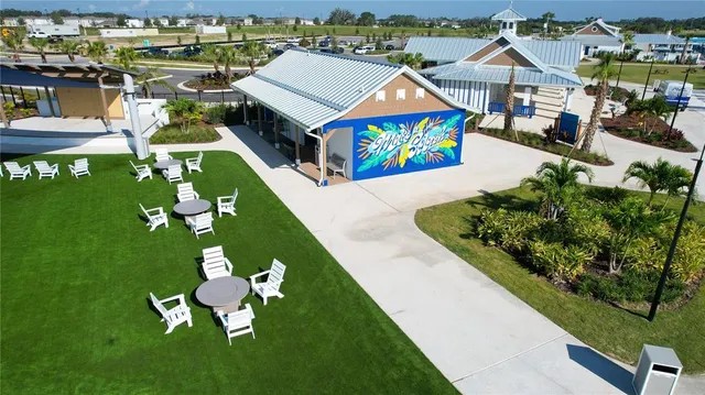 an aerial view of a house with garden space seating area and car parked