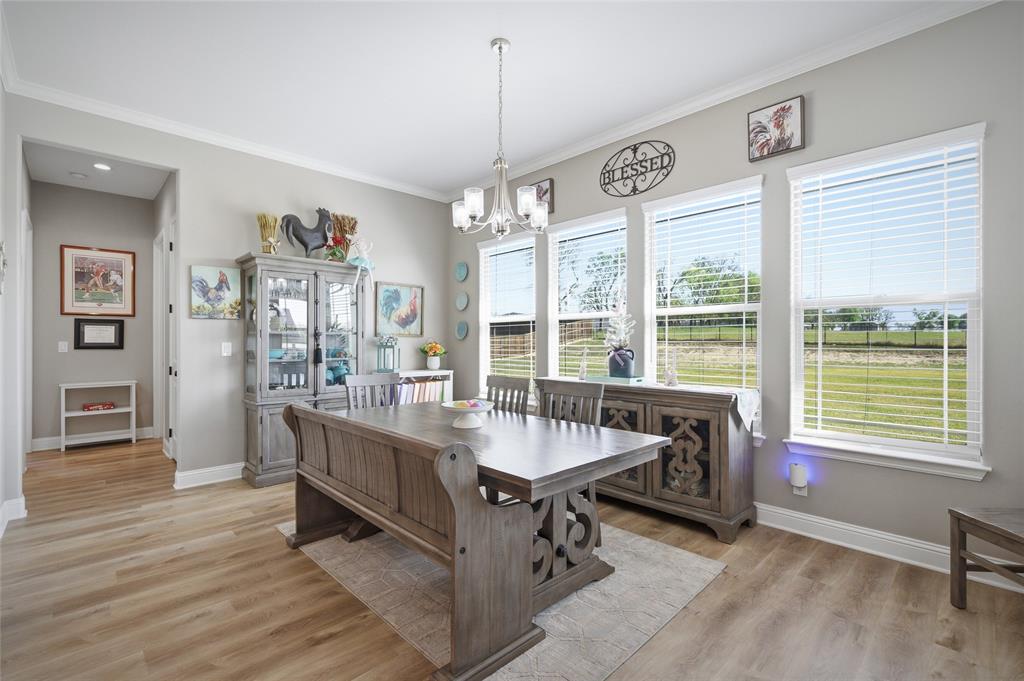 1065 Old Highway Howe, TX 75459 - Photo 19 of 39 Dining area with light wood-type flooring, a chandelier, and crown molding