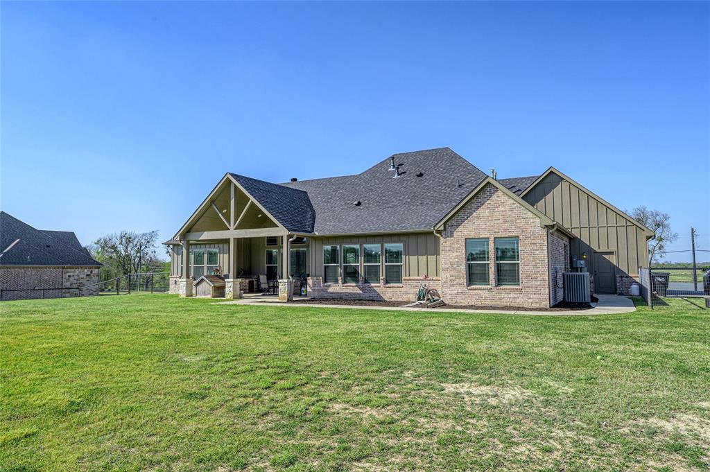 1065 Old Highway Howe, TX 75459 - Photo 34 of 39 Rear view of house with board and batten siding, a patio, brick siding, and a shingled roof