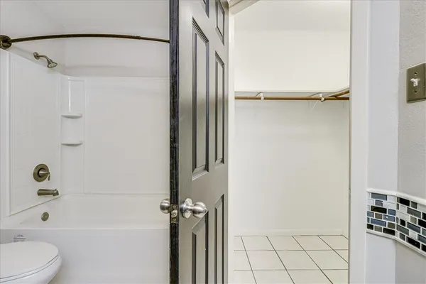 a bathroom with a bathtub a toilet and a shower