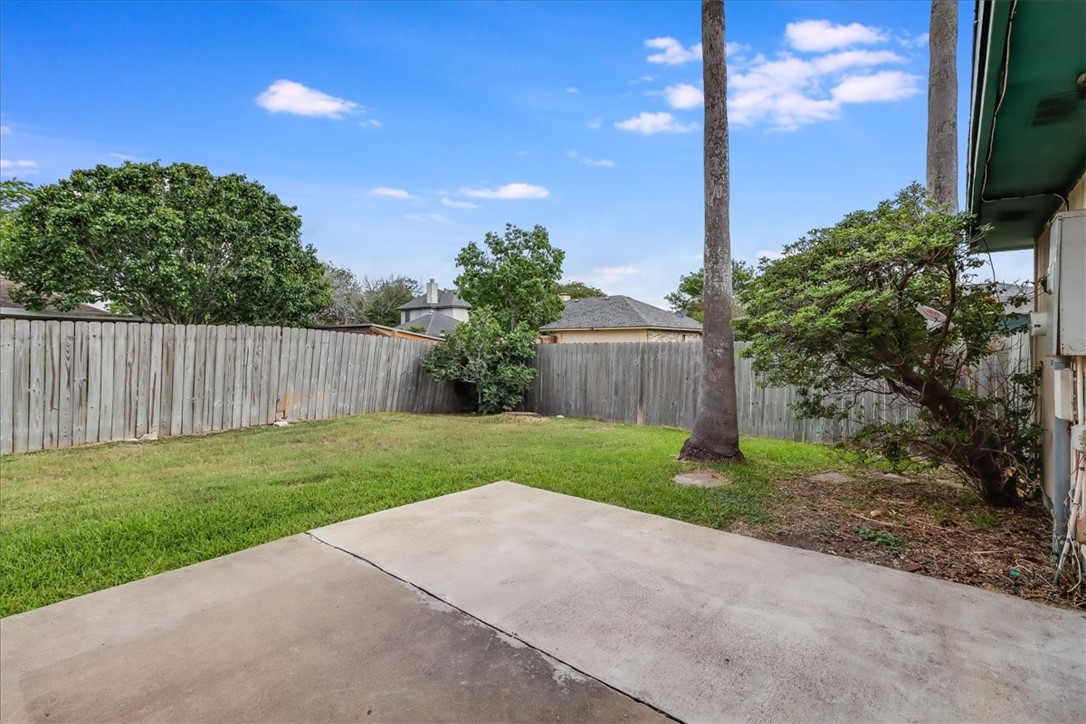 2938 River Crest Road Corpus Christi, TX 78415 - Photo 38 of 39 a view of a back yard with flower plants and wooden fence