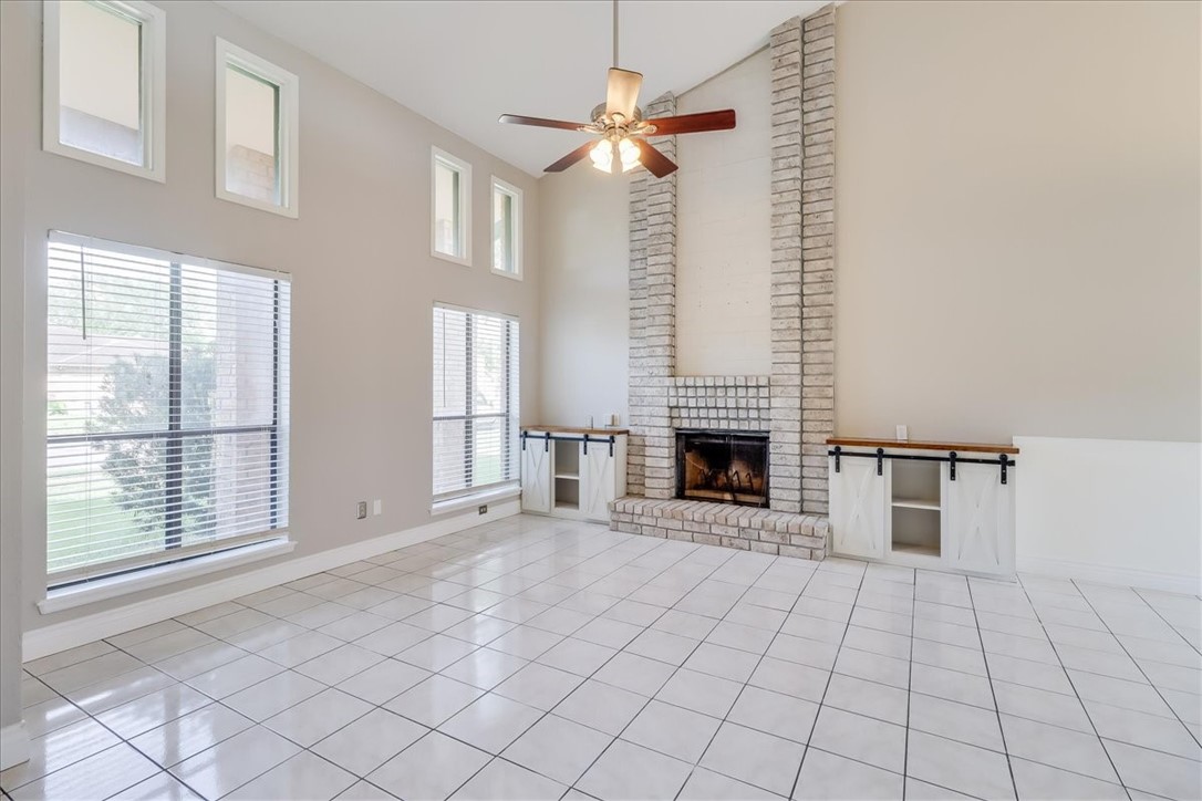2938 River Crest Road Corpus Christi, TX 78415 - Photo 6 of 39 a view of an empty room with a fireplace and a window