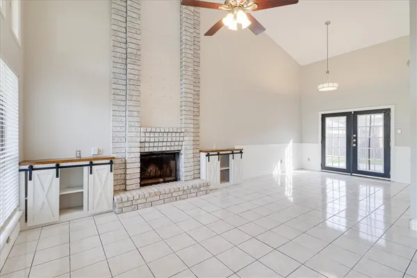 a view of an empty room with window and fireplace