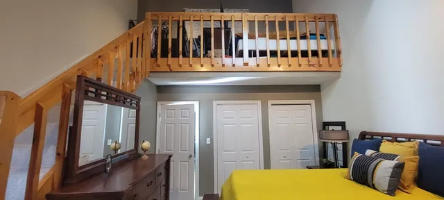 a bedroom with furniture and a gate