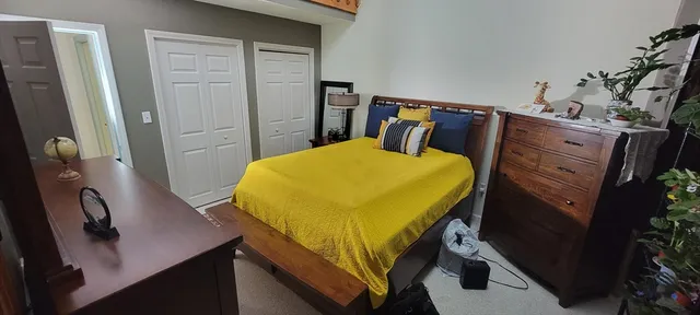 a blue chair sitting in a room next to a window