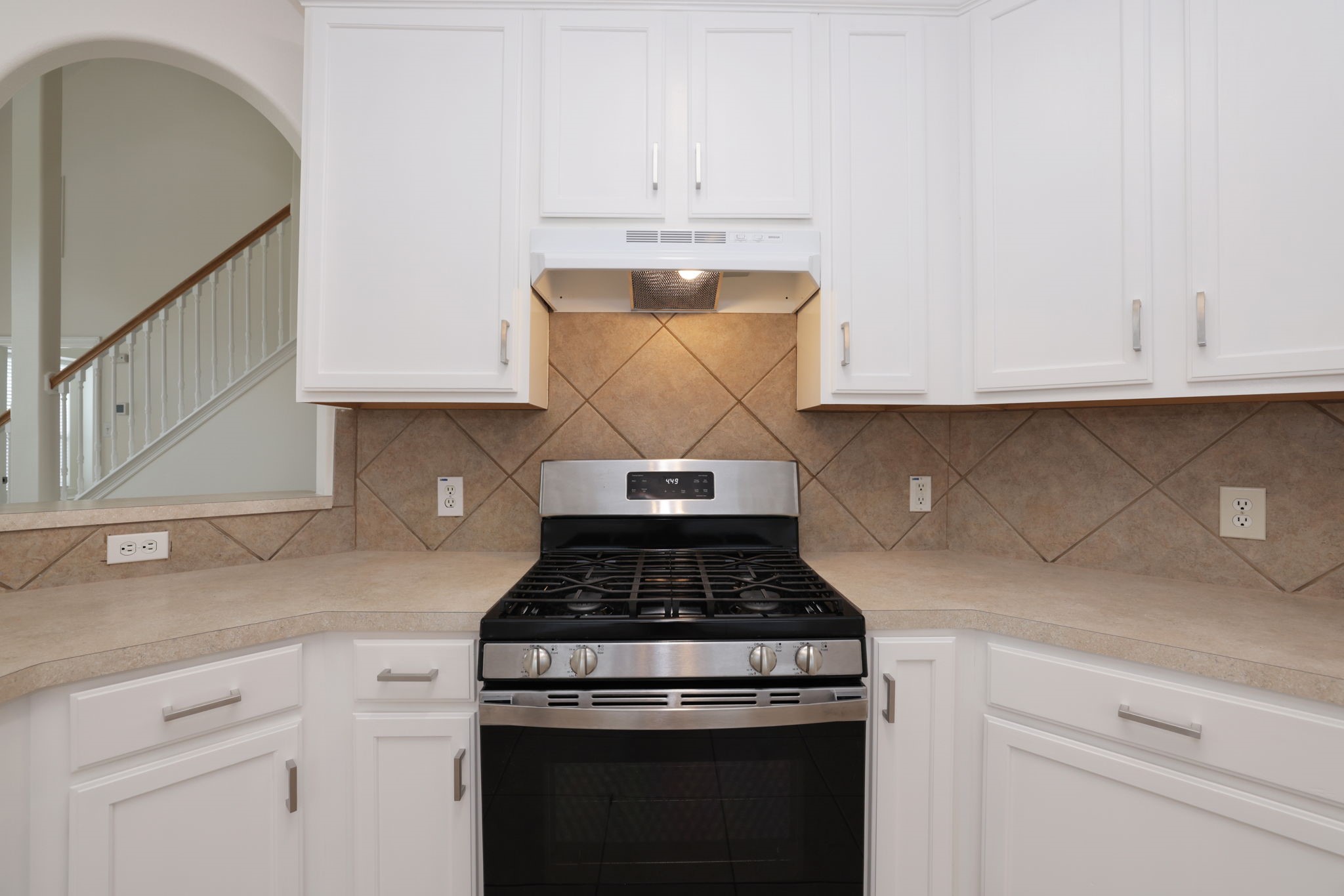 3031 Country Boy Court Spring, TX 77373 - Photo 12 of 35 a kitchen with granite countertop white cabinets and black stove