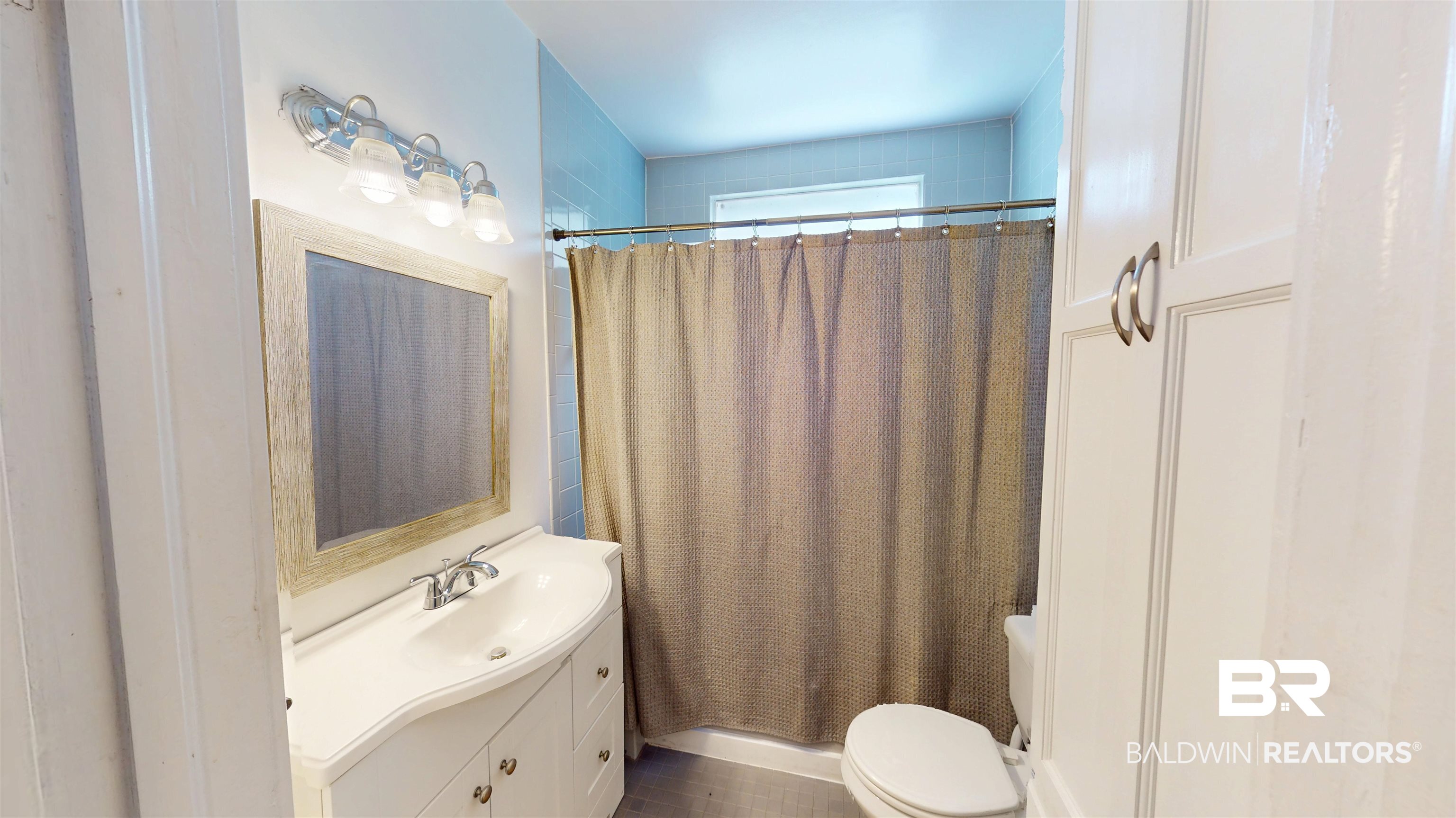 266 Westwood Street Mobile, AL 36606 - Photo 20 of 34 Bathroom with vanity, toilet, and shower / tub combo with curtain