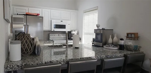 a kitchen with a sink stove and refrigerator