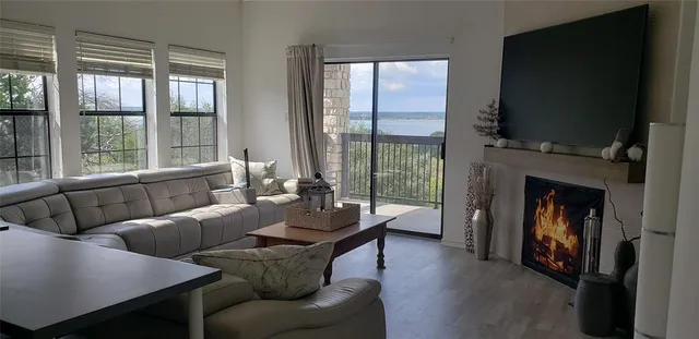 a living room with furniture a flat screen tv and a fireplace