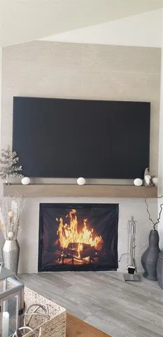 a view of fireplace with wooden floor