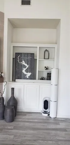 a room with a washing machine and cabinets