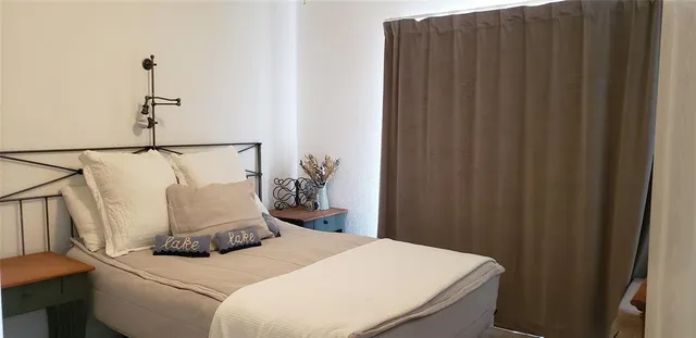 a bedroom with a bed and a mirror