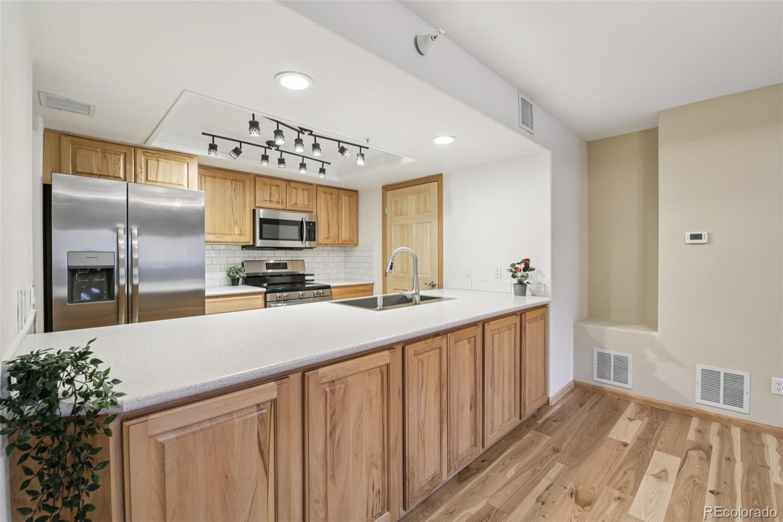 23674 Pondview Place, Unit B Golden, CO 80401 - Photo 11 of 35 a kitchen with stainless steel appliances a refrigerator and a sink