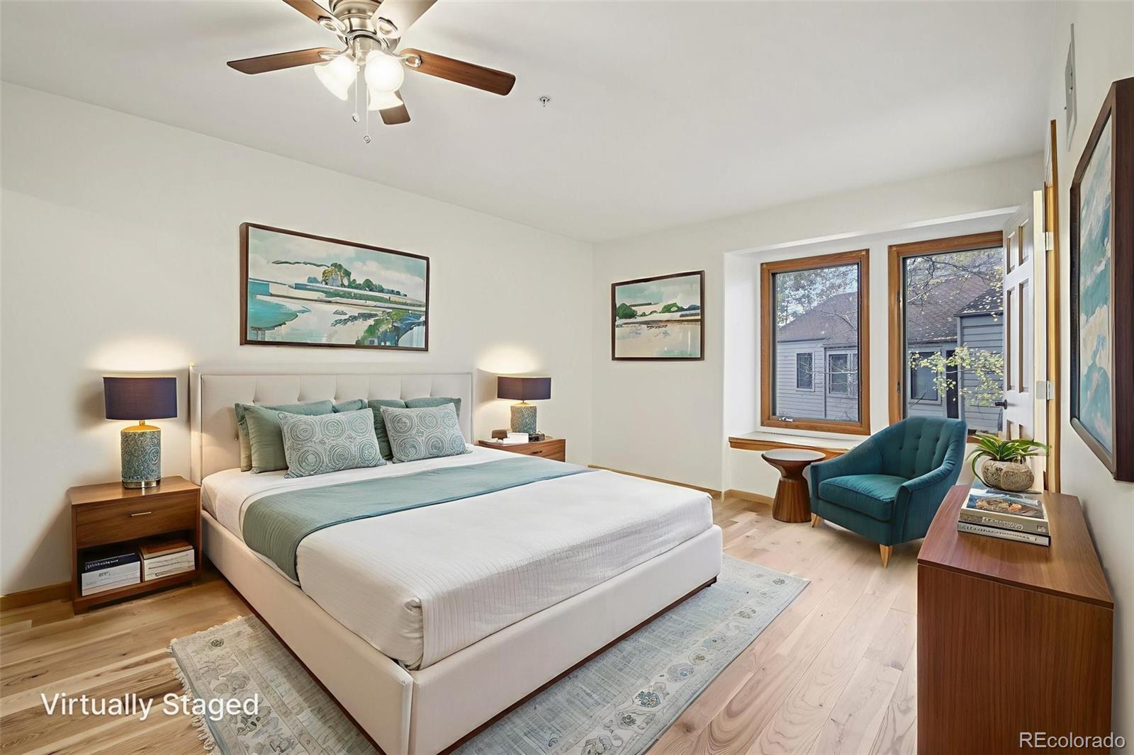 23674 Pondview Place, Unit B Golden, CO 80401 - Photo 12 of 35 a bedroom with a bed and a chandelier