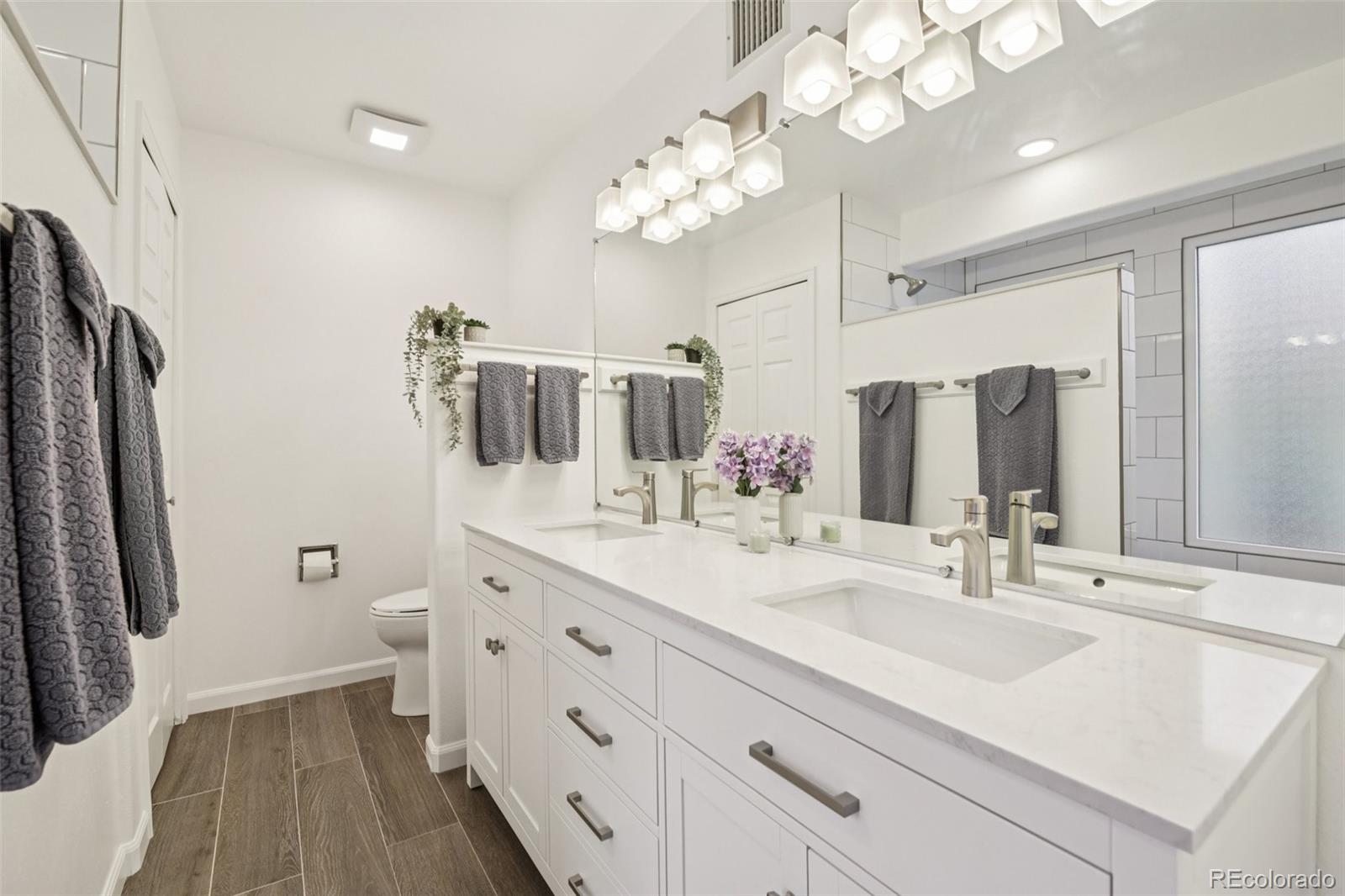 23674 Pondview Place, Unit B Golden, CO 80401 - Photo 15 of 35 a bathroom with a sink a double vanity and a mirror
