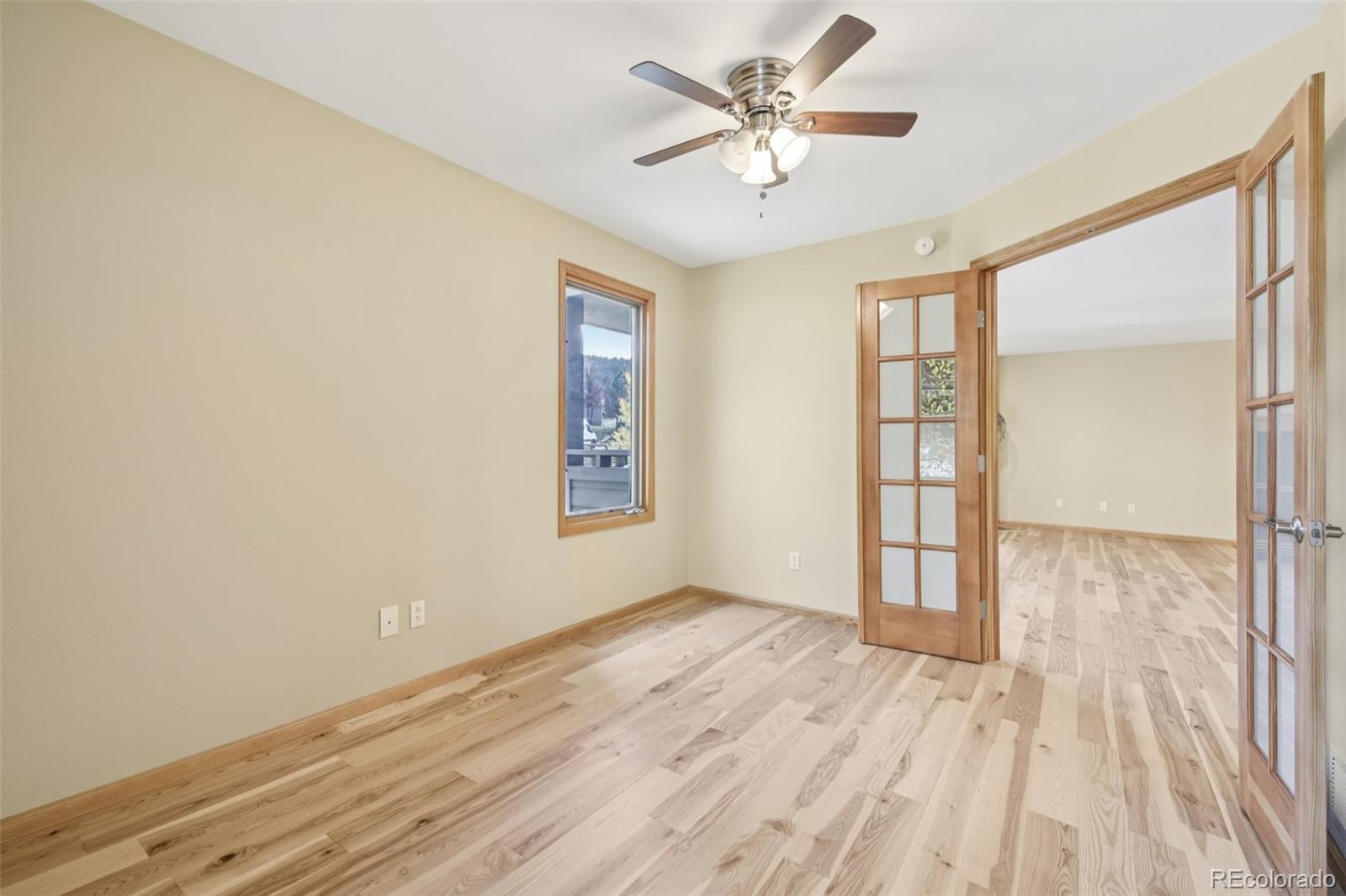 23674 Pondview Place, Unit B Golden, CO 80401 - Photo 18 of 35 wooden floor in an empty room with a window